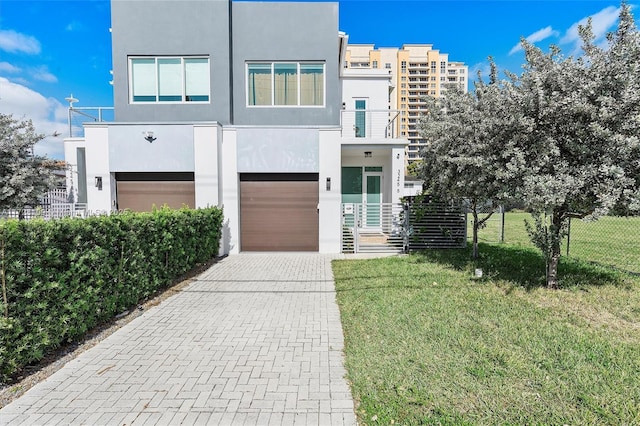 view of front of house with a garage and a front yard