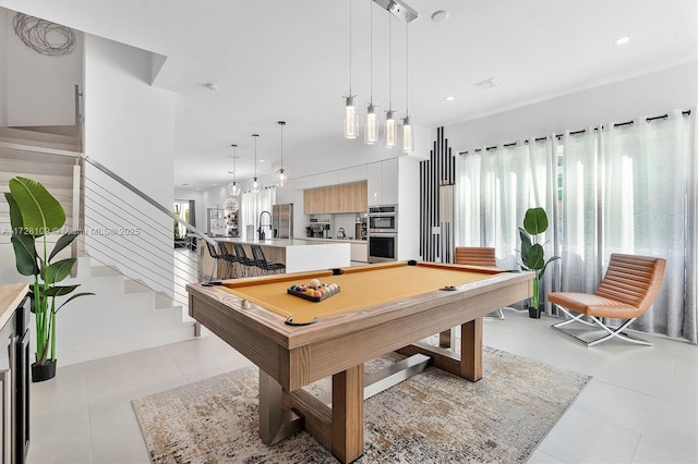 recreation room featuring light tile patterned floors, pool table, plenty of natural light, and sink