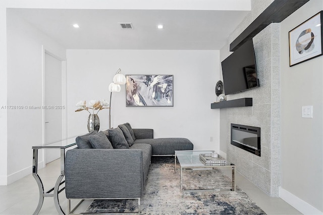 living room featuring a tile fireplace