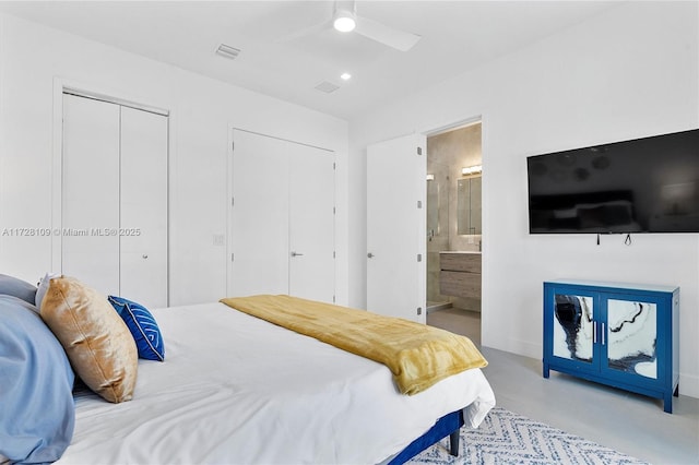 bedroom featuring ceiling fan, connected bathroom, and two closets