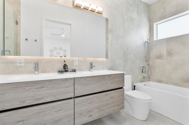 full bathroom featuring ceiling fan, vanity, tile walls, toilet, and tile patterned floors