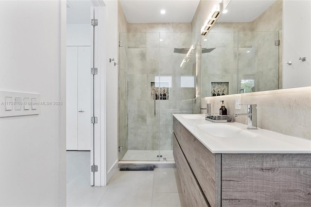 bathroom featuring an enclosed shower, vanity, and tile patterned floors