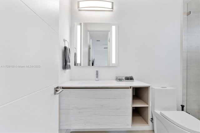 bathroom with toilet and vanity