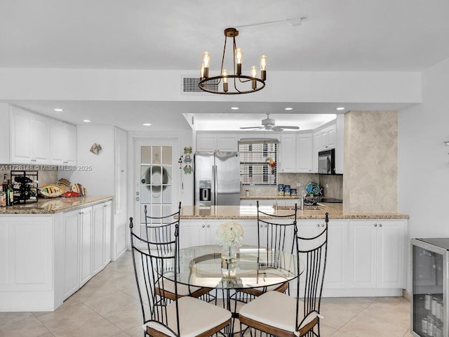 dining area with wine cooler, light tile patterned floors, sink, and ceiling fan