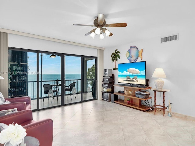 living room with light tile patterned flooring and ceiling fan