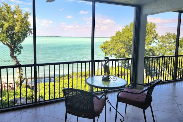 sunroom / solarium with plenty of natural light and a water view