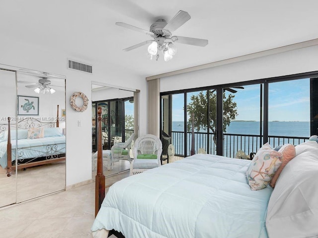 tiled bedroom with access to exterior, ceiling fan, and a water view