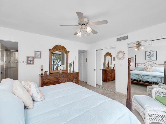 bedroom featuring multiple closets, light tile patterned floors, and ceiling fan