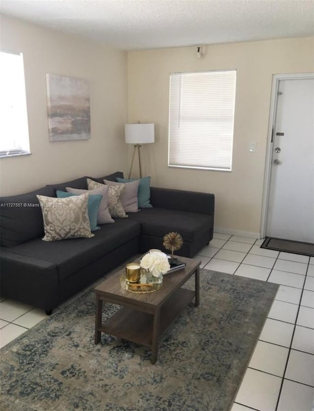 tiled living room featuring a textured ceiling