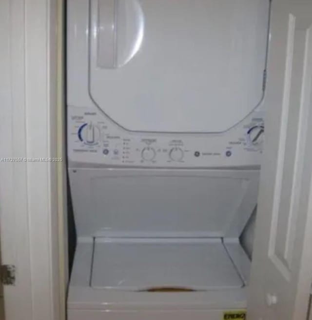 laundry area featuring stacked washer and clothes dryer