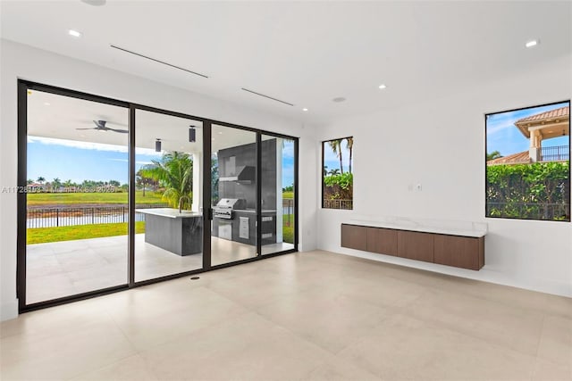 empty room with ceiling fan and a water view