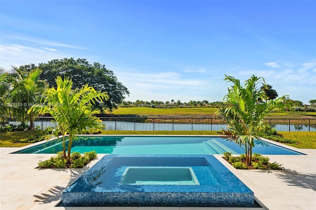 view of swimming pool with an in ground hot tub, a water view, and a patio