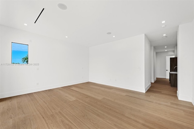 empty room with light hardwood / wood-style floors