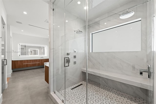 bathroom featuring walk in shower and vanity