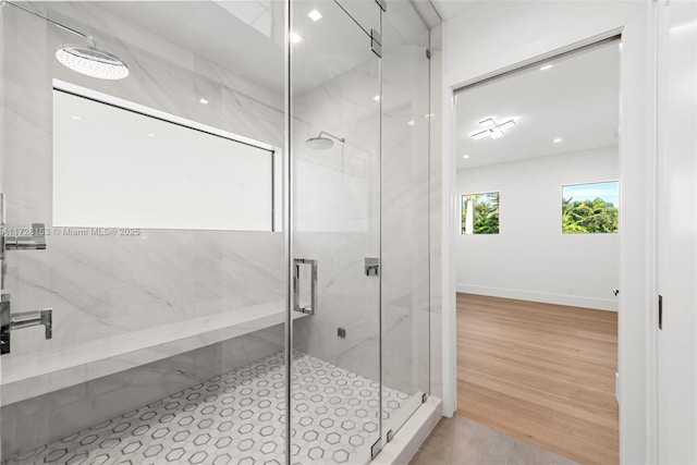 bathroom featuring a shower with shower door and wood-type flooring