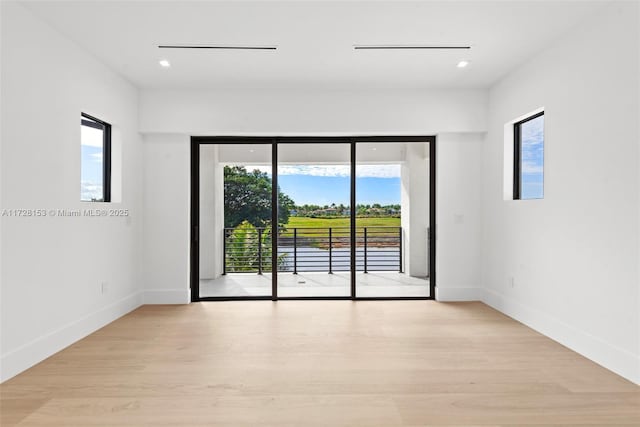 unfurnished room with light hardwood / wood-style flooring