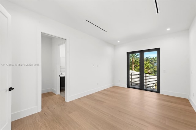 empty room featuring light hardwood / wood-style flooring and french doors