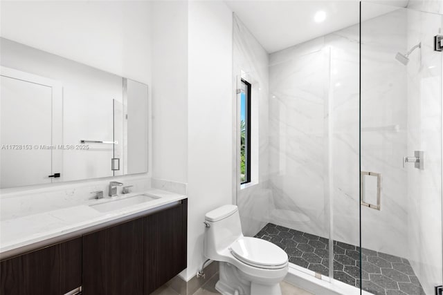 bathroom featuring toilet, vanity, and walk in shower