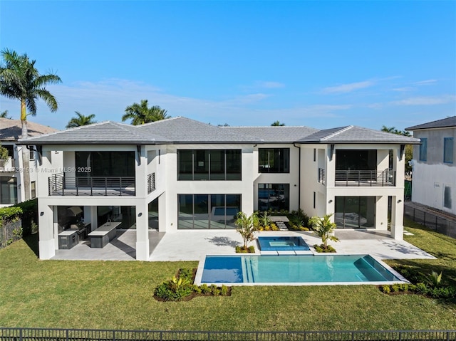 back of house with a balcony, a fenced in pool, a yard, and a patio