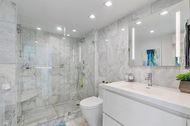 bathroom featuring a shower with shower door, tile walls, toilet, and vanity