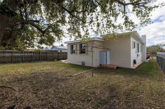 back of property featuring a lawn