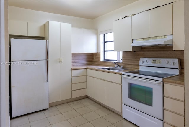 kitchen featuring white cabinetry, sink, and white appliances