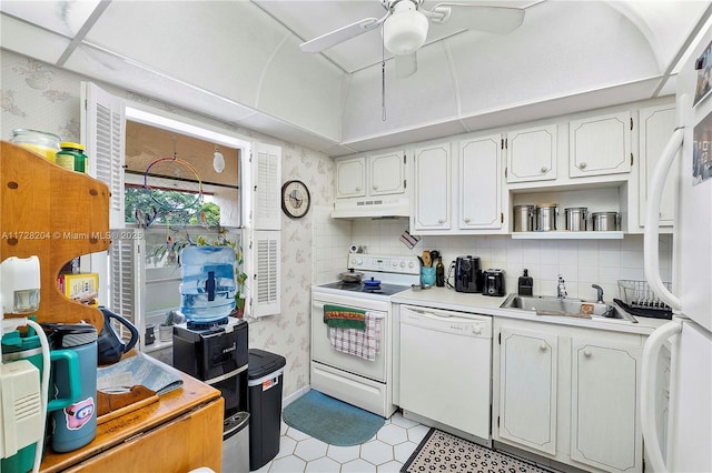 kitchen with white appliances, white cabinets, tasteful backsplash, sink, and ceiling fan