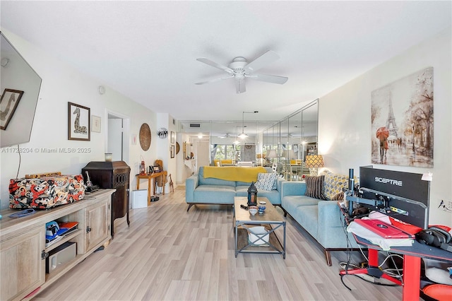 living room featuring ceiling fan and light hardwood / wood-style flooring