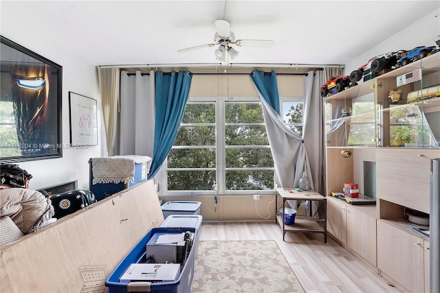 interior space with ceiling fan and light hardwood / wood-style floors