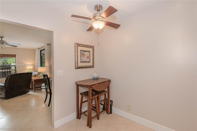 interior space featuring ceiling fan and a textured ceiling