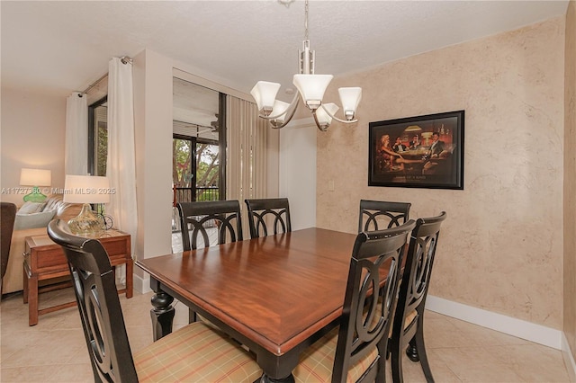 tiled dining space featuring an inviting chandelier