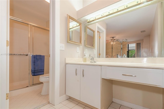 bathroom with toilet, tile patterned floors, an enclosed shower, and vanity