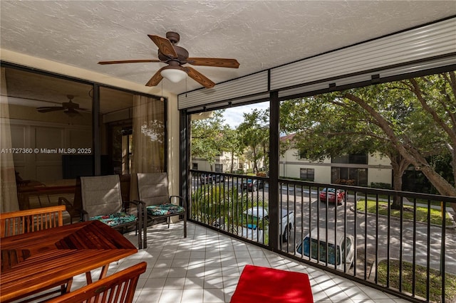 sunroom / solarium featuring ceiling fan