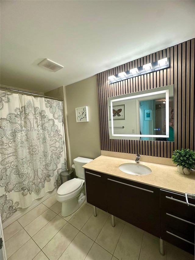 bathroom with tile patterned flooring, toilet, vanity, and visible vents