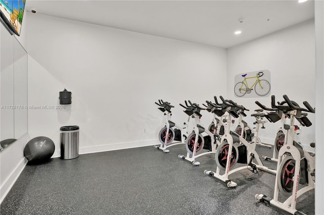 exercise room featuring recessed lighting and baseboards