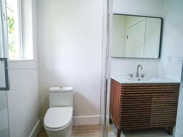 bathroom featuring toilet and vanity