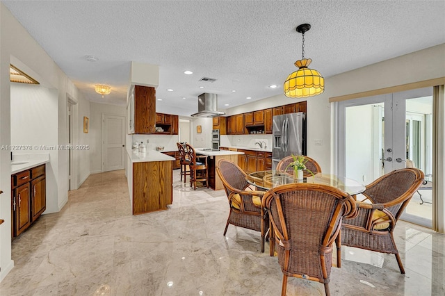 dining area with french doors, sink, and a textured ceiling