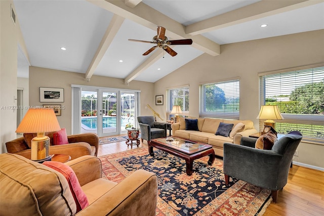 living room featuring light wood-type flooring, ceiling fan, and lofted ceiling with beams