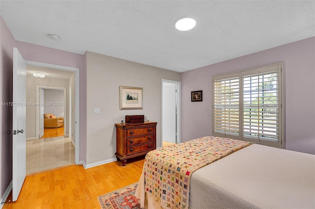 bedroom featuring a textured ceiling and hardwood / wood-style floors