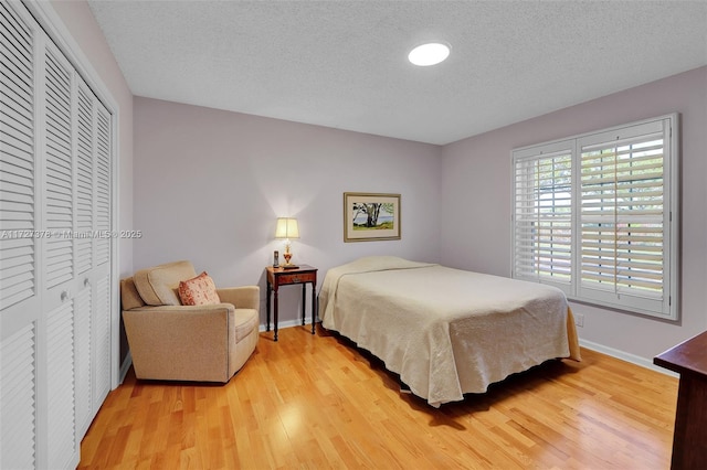 bedroom featuring a textured ceiling and hardwood / wood-style flooring