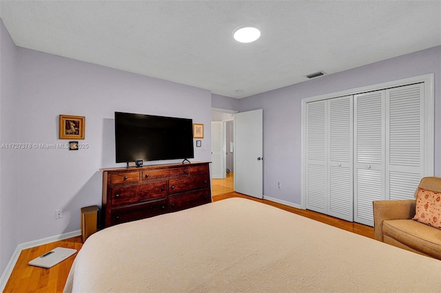 bedroom with a closet and light hardwood / wood-style flooring