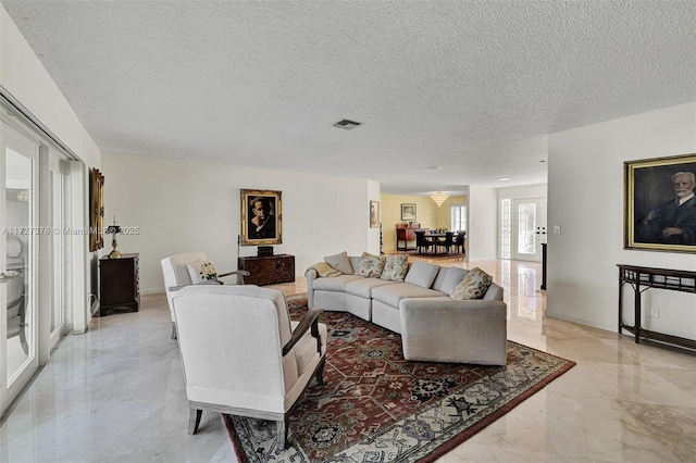 living room featuring a textured ceiling and french doors