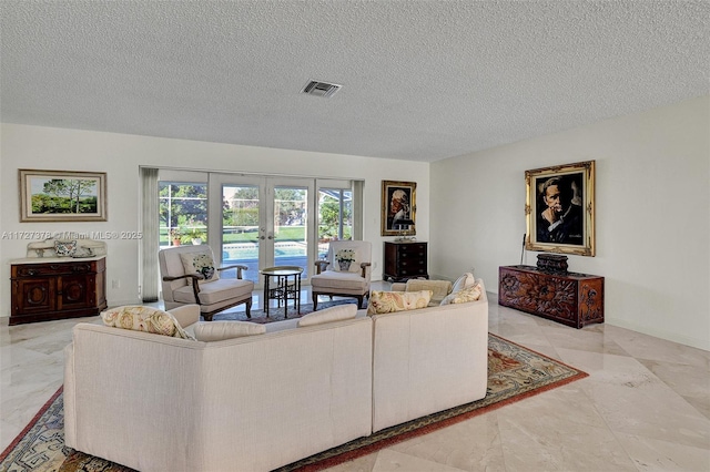 living room with french doors and a textured ceiling