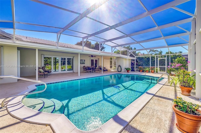 view of pool with a lanai, ceiling fan, and a patio area