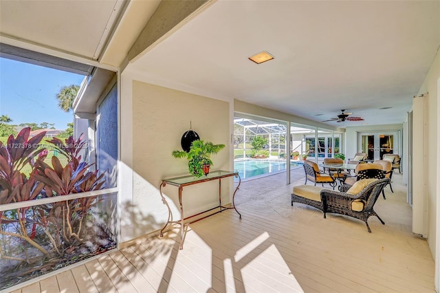 exterior space featuring ceiling fan and a pool