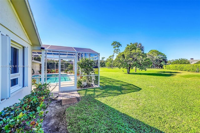 view of yard with glass enclosure