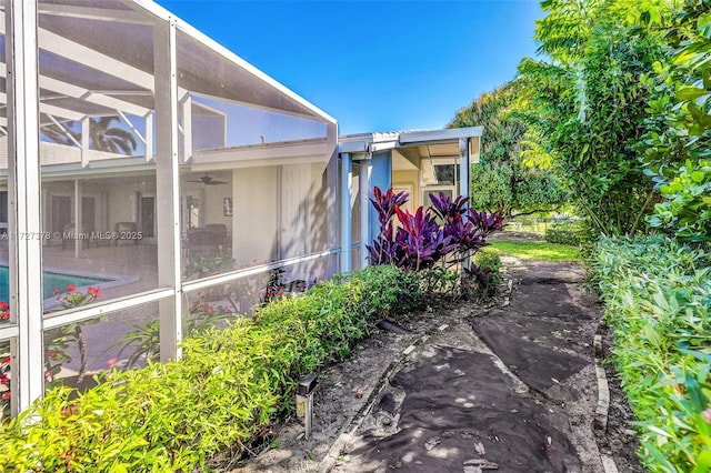 view of side of home with a lanai