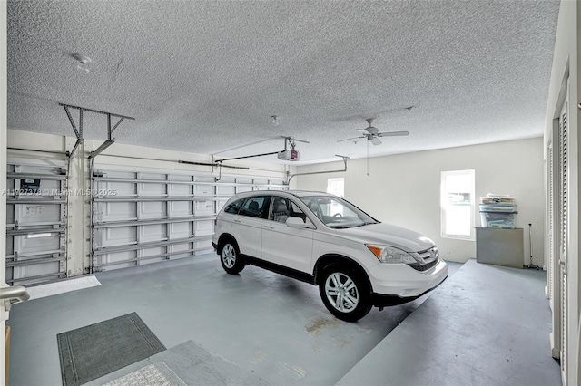 garage with ceiling fan and a garage door opener