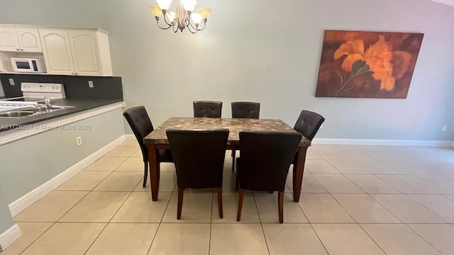 dining room with light tile patterned floors, sink, and a notable chandelier