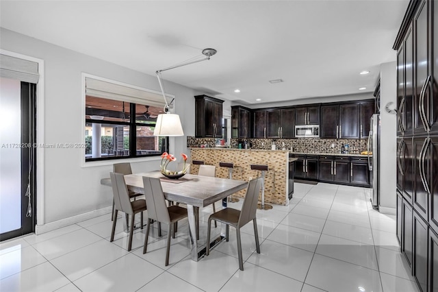 dining area featuring light tile patterned flooring